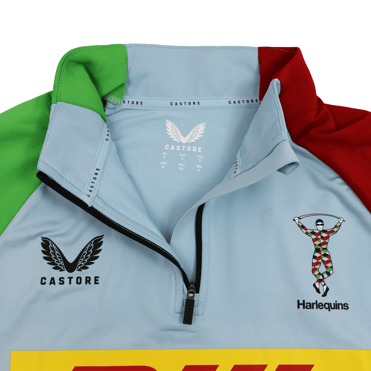 Close-up of the Harlequins 24/25 Matchday 1/4 Zip Midlayer by Castore in light blue, showcasing a partial zip, Castore and DHL logos, and the iconic Harlequins team crest.