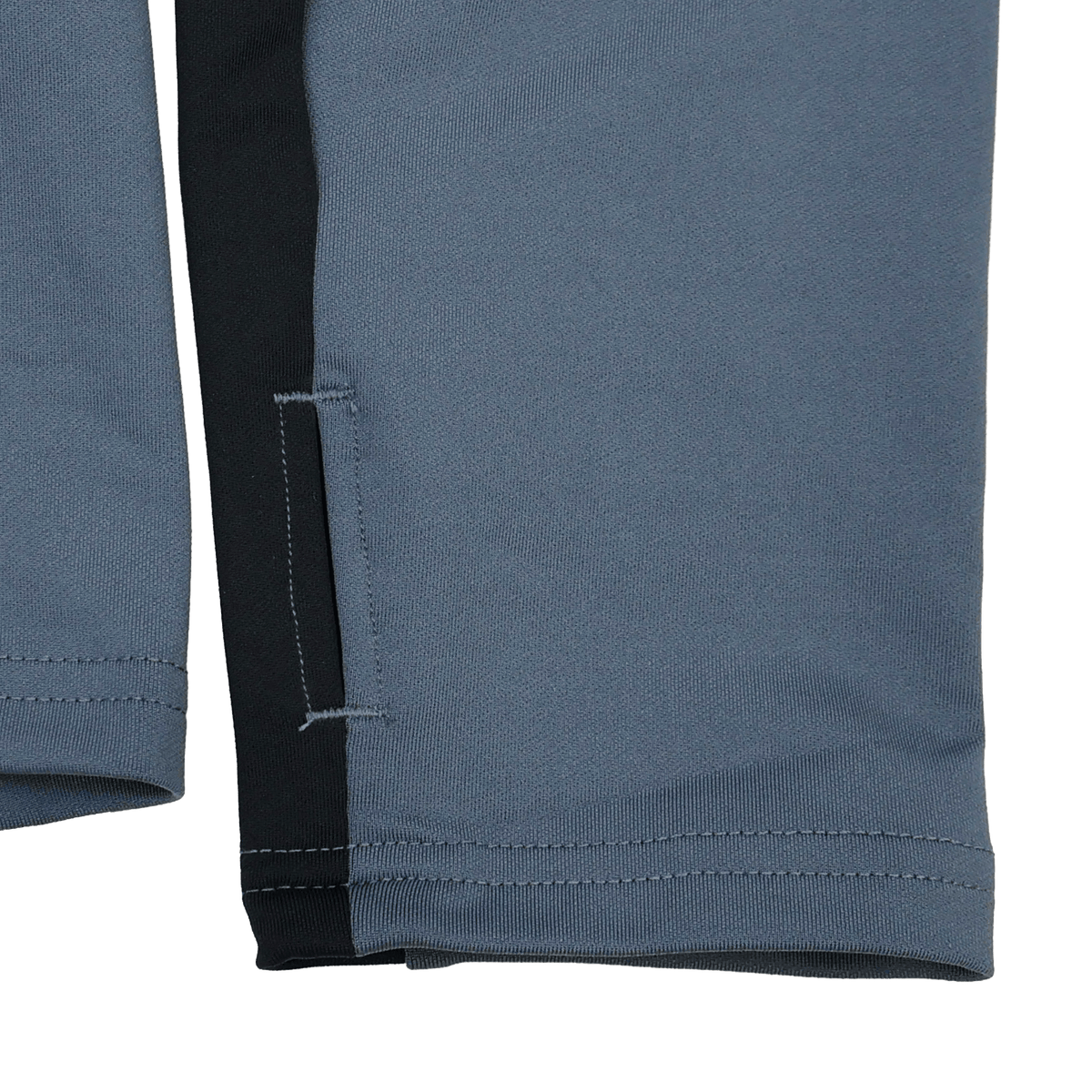 Close-up of gray and black pant legs with stitching and a side slit—ideal to pair with your Castore Bath 24/25 Pro Players 1/4 Zip Midlayer for a complete sporty look.
