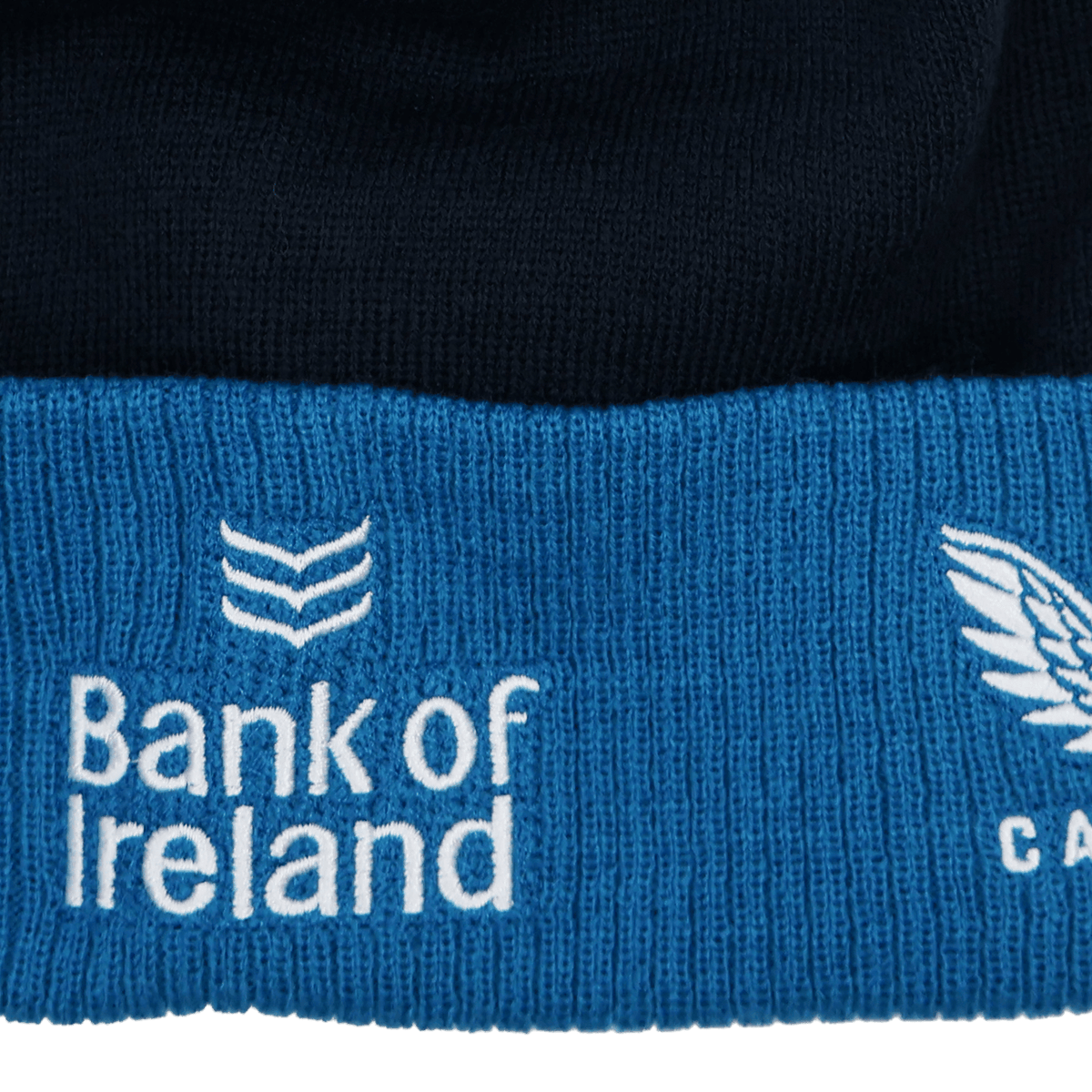 Close-up of the Leinster 24/25 Bobble Beanie by Castore, a blue and black knit hat featuring "Bank of Ireland" and a logo embroidered in white.