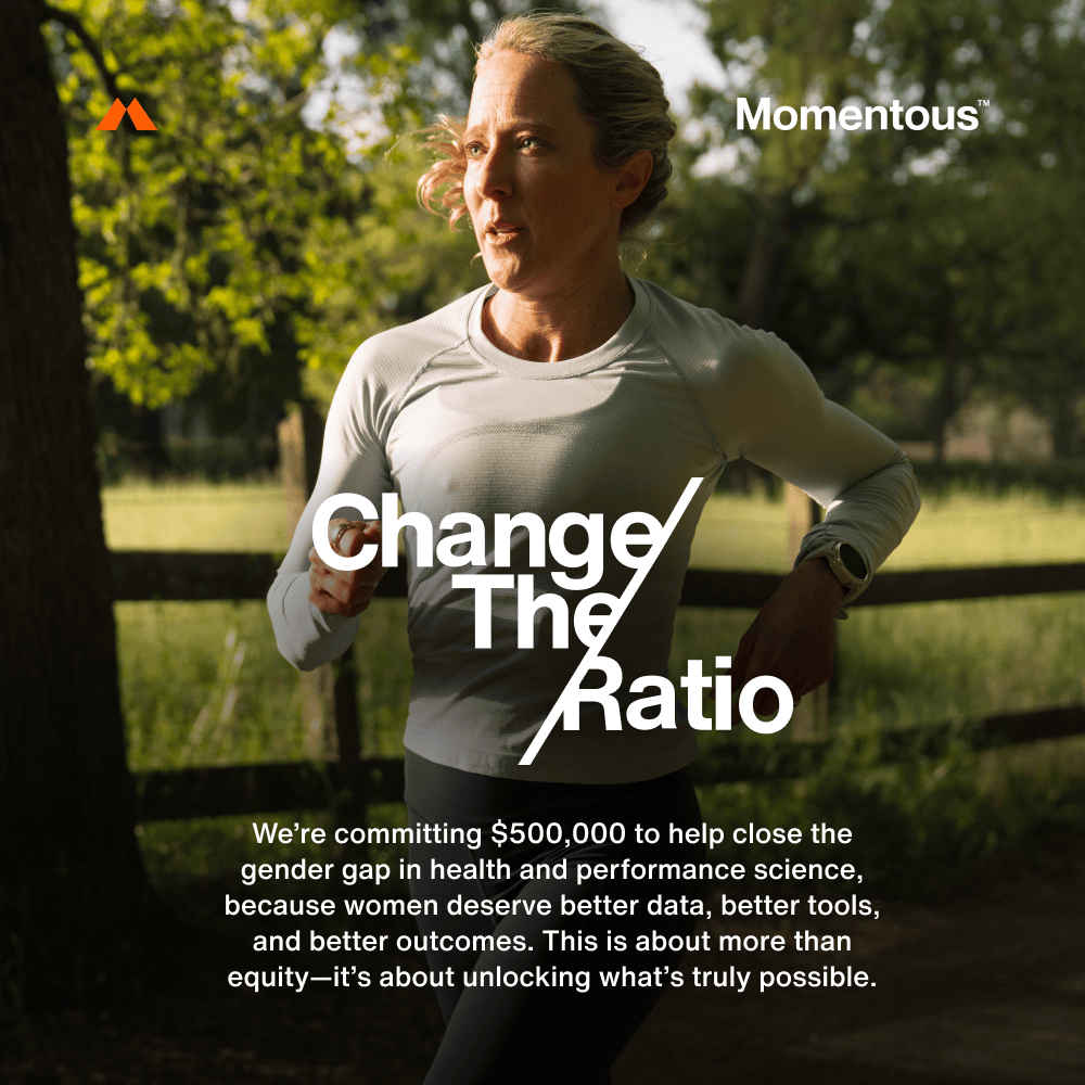 A woman runs outdoors on a sunny day; overlaid text announces Momentous’ $500,000 commitment to close the gender gap in health science, supporting initiatives like The Women’s Three™ daily health system and iron supplements.