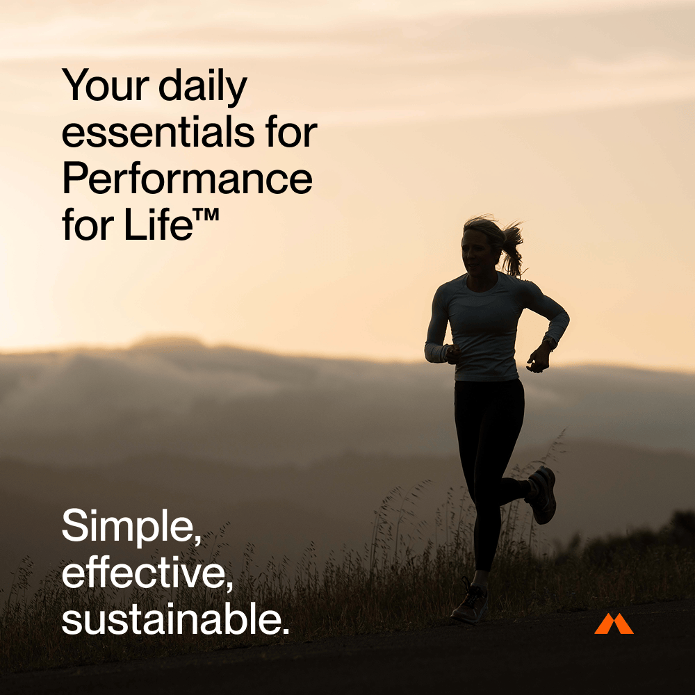 A woman runs at sunrise with text highlighting Momentous The Women’s Three™ by Momentous—a daily health system designed for performance, simplicity, effectiveness, and sustainability, featuring essentials like an iron supplement for women.