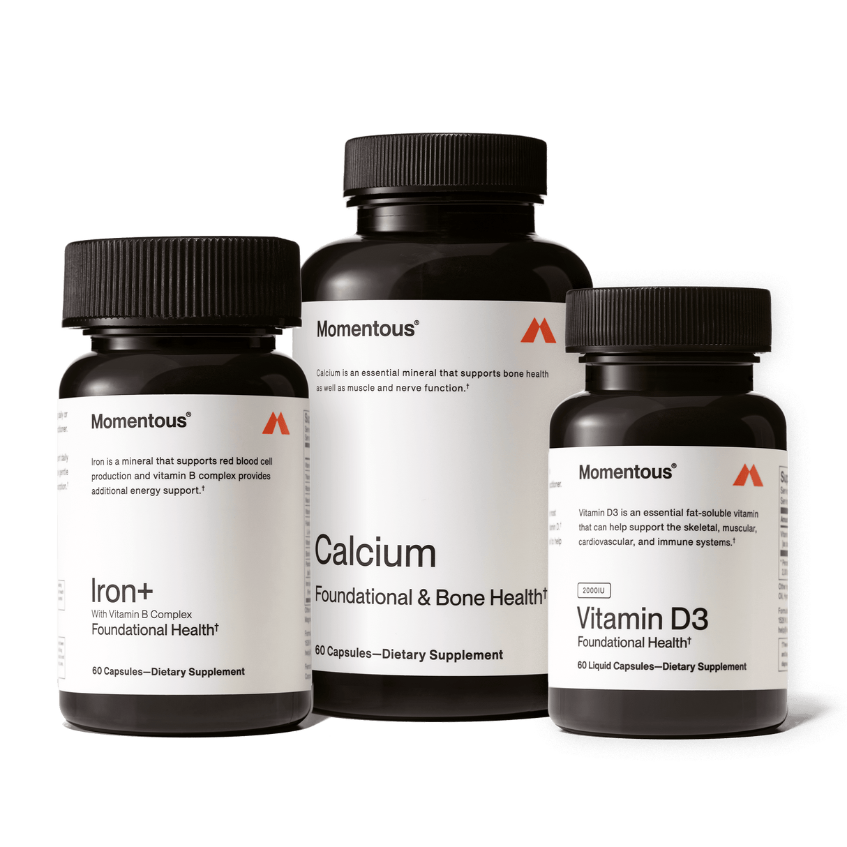 Three bottles of Momentous The Women’s Three™ by Momentous are shown, featuring Iron+, Calcium, and Vitamin D3 supplements as a daily health system for women against a plain background.