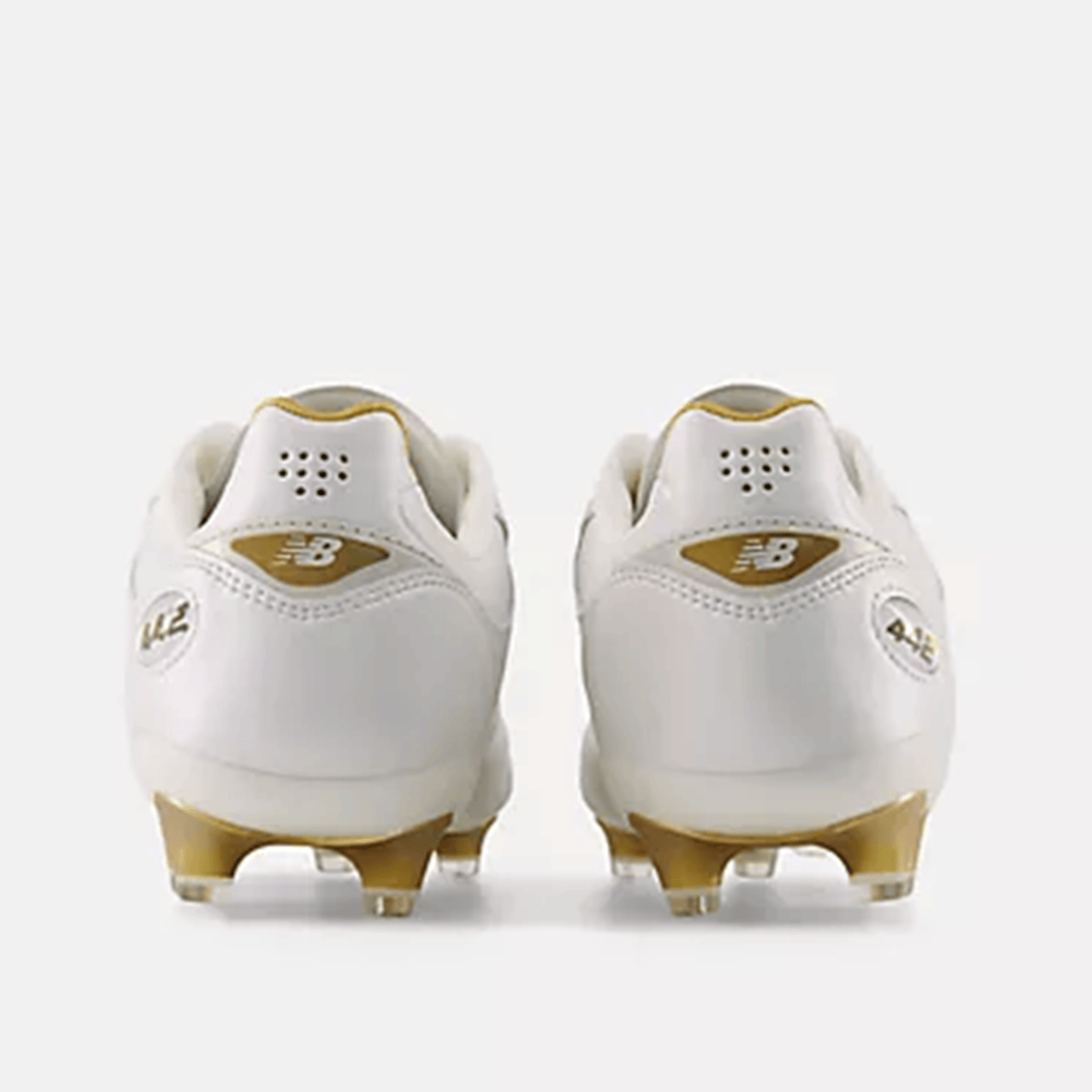 The New Balance Wide 442 Elite FG v3 in Sea Salt/Gold Metallic is shown from the back on a plain background, highlighting its wide fit and firm ground performance.