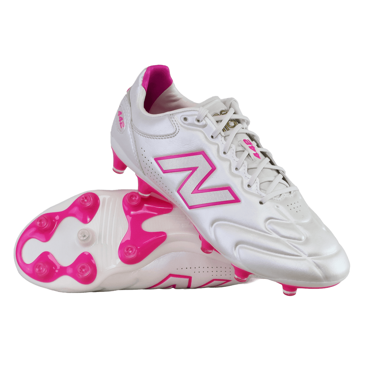 A pair of New Balance 442 Elite FG v3 soccer cleats in Sea Salt/Pink Heat, featuring pink accents and studs with the New Balance logo, displayed on a white background.