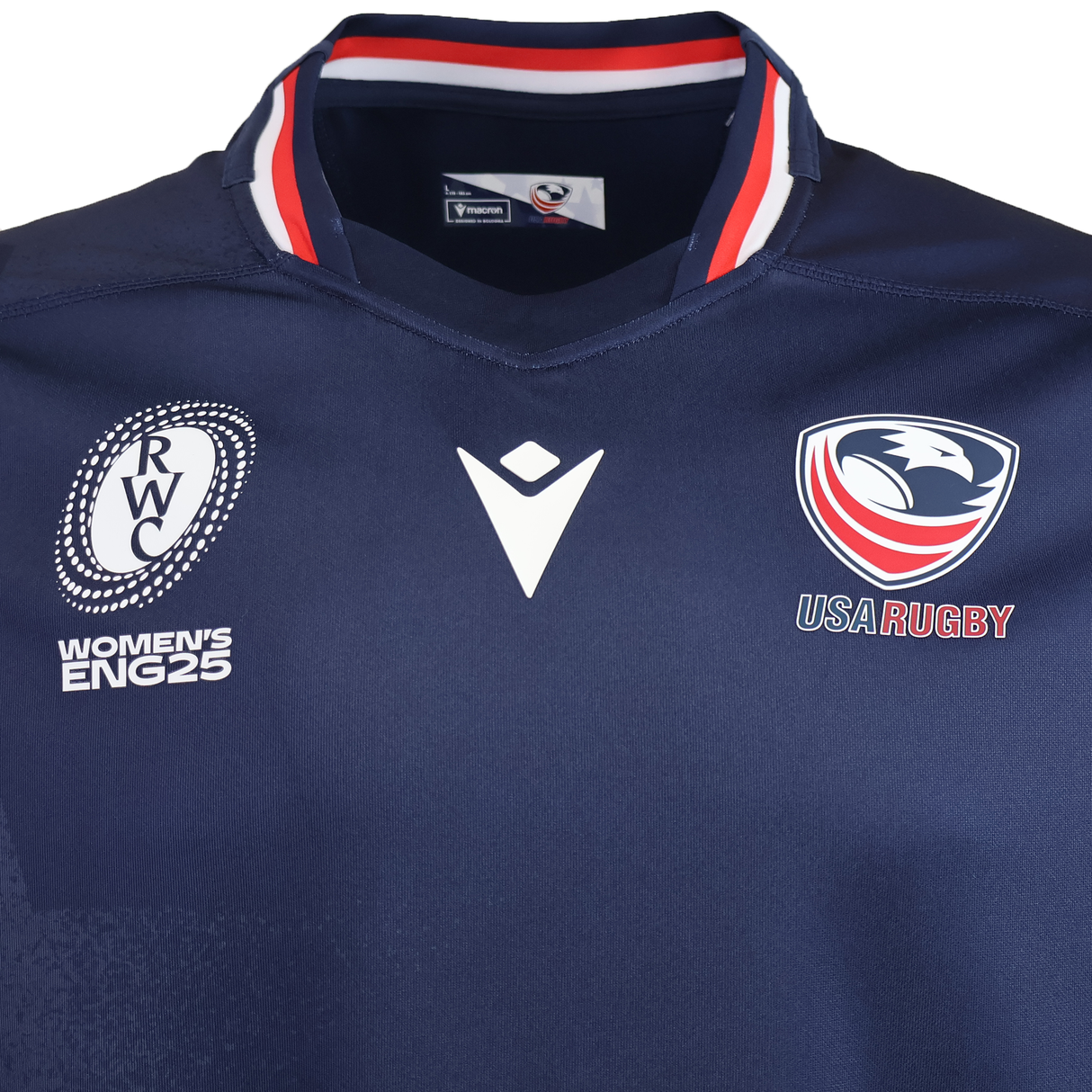 The USA Rugby WRWC25 Replica Home Jersey by Macron features a white, red, and blue collar and displays the USA Rugby and Women's Rugby World Cup 2025 logos.