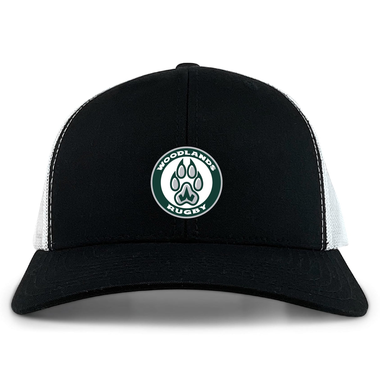 The Woodlands Youth Retro Trucker Cap by EMB S&S Activewear features a black and white design, a circular "Woodlands Rugby" paw print embroidery on the front, and an adjustable snapback closure.