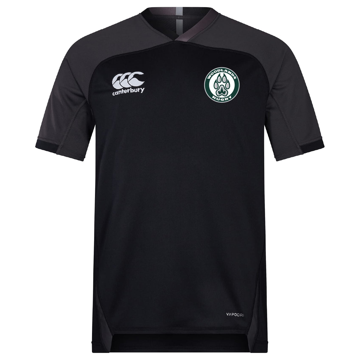 The Woodlands Youth Vapodri Evader Jersey by EMB Canterbury is a black short-sleeve rugby jersey with a round neck, Canterbury logo on the right chest, wolf paw emblem on the left, and moisture-wicking tech for comfort.