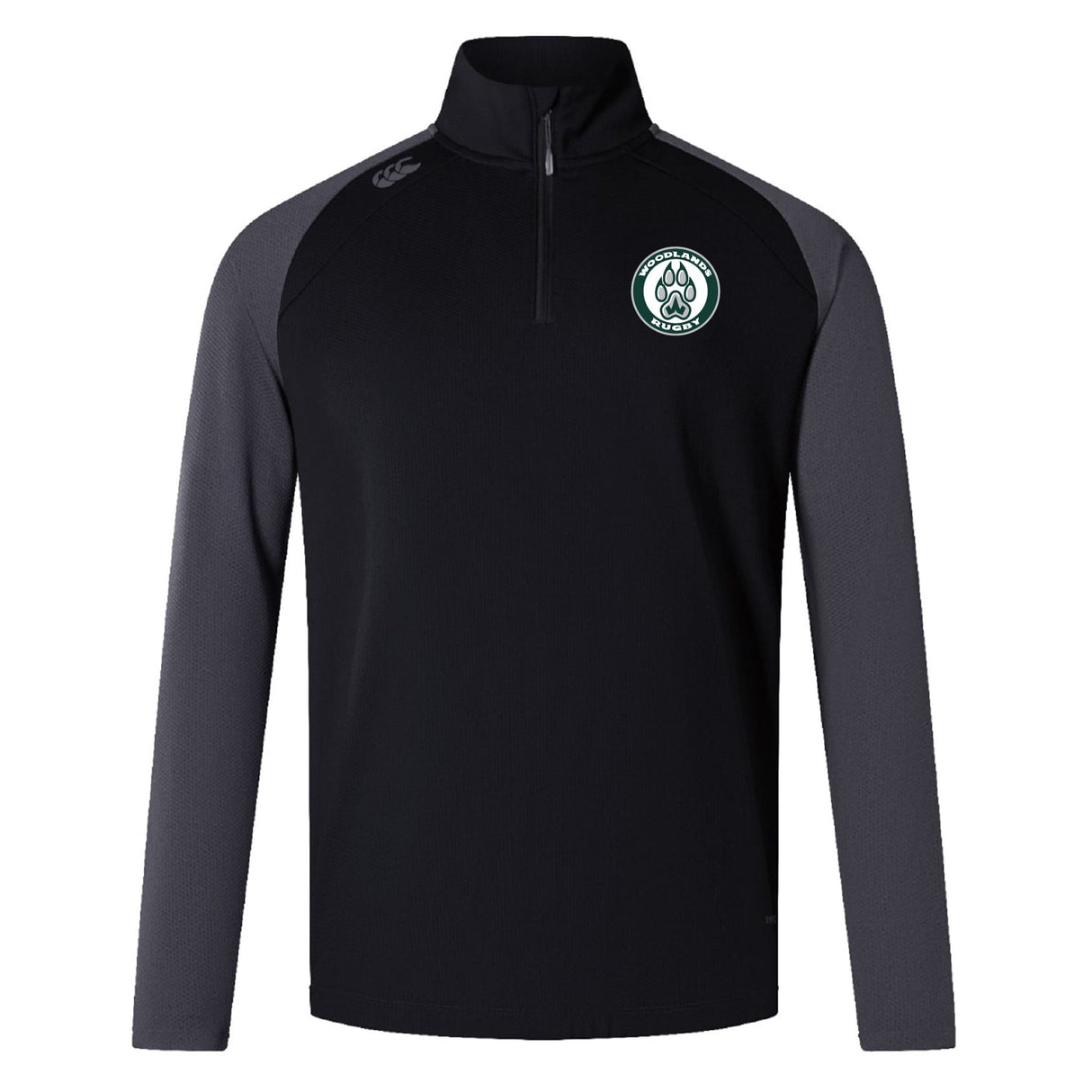 The Woodlands Youth Women's Elite First Layer by EMB Canterbury is a black quarter-zip top with dark gray sleeves, a circular logo on the left chest, and moisture-wicking VapoDri technology.