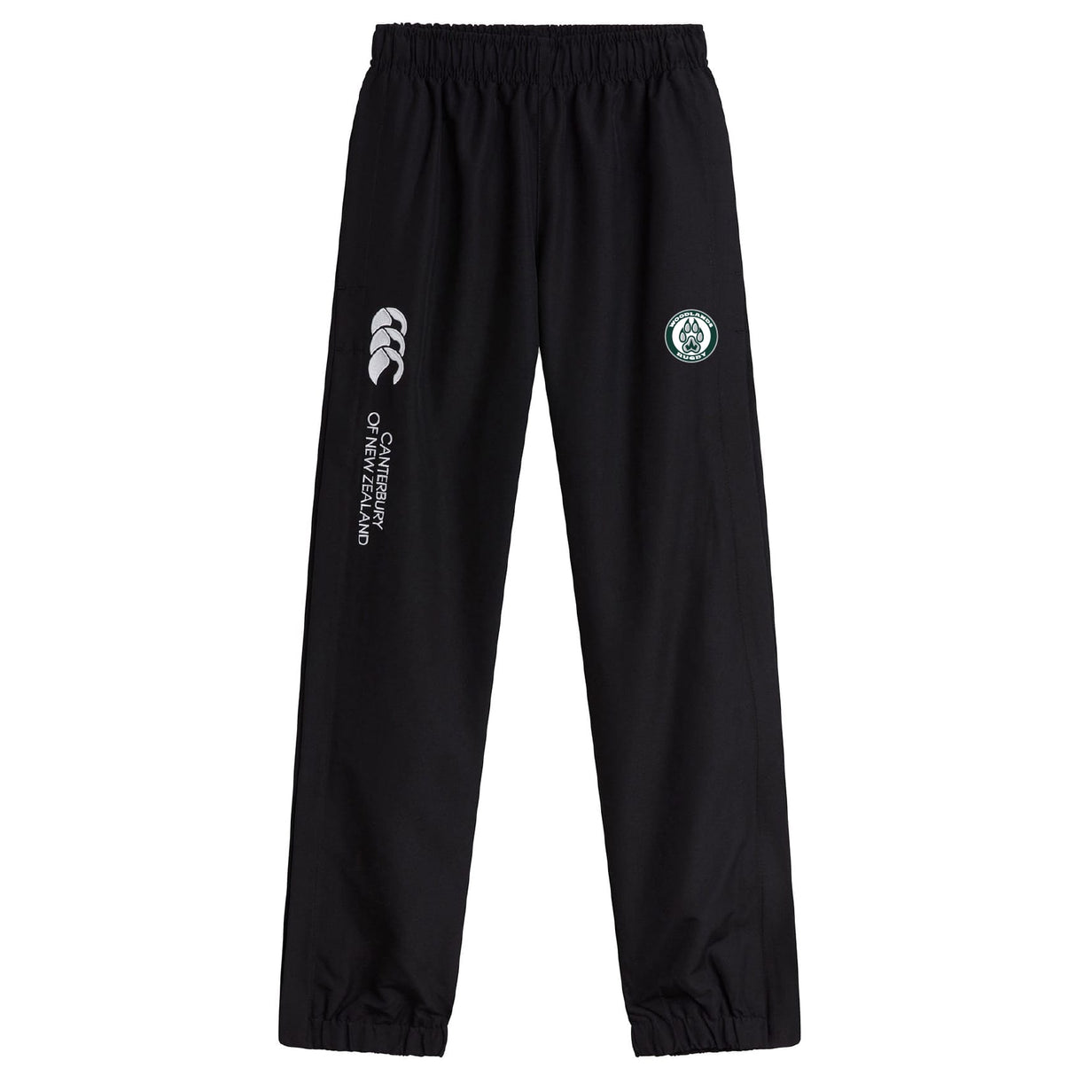 Woodlands Youth Cuffed Hem Stadium Pant by EMB Canterbury features an elastic waistband, cuffed hem, white Canterbury branding, and a circular green and white logo on the left thigh.