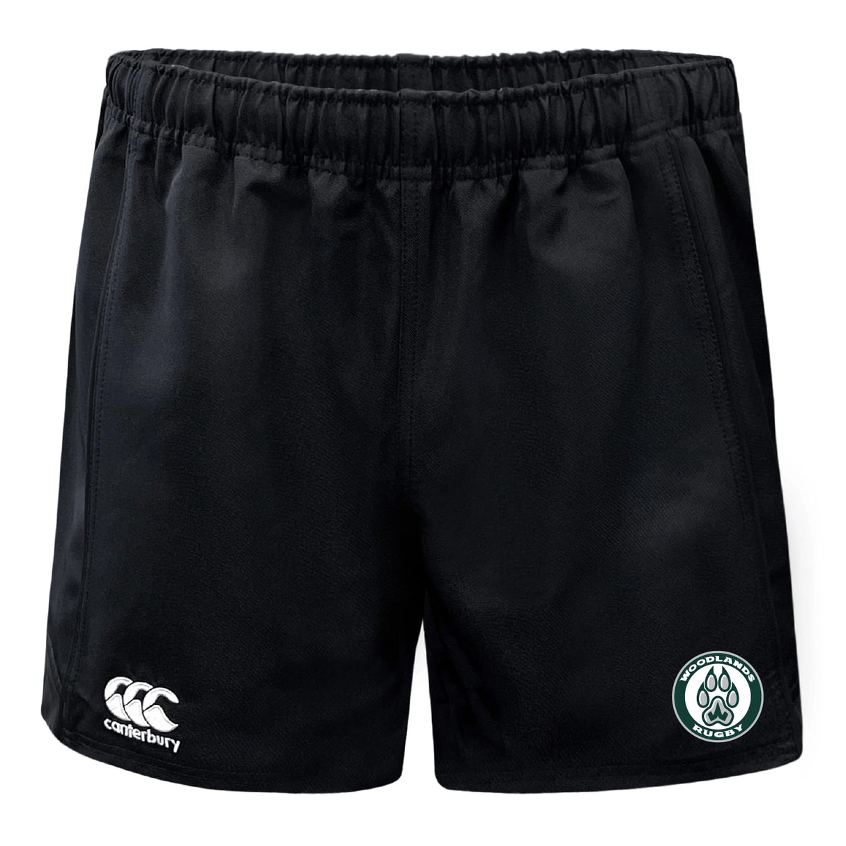 The Woodlands Youth Professional Polyester Rugby Short by EMB Canterbury features black fabric, an elastic waistband, a white Canterbury logo on the left hem, and a green and white Woodland Rugby Club badge on the right hem.