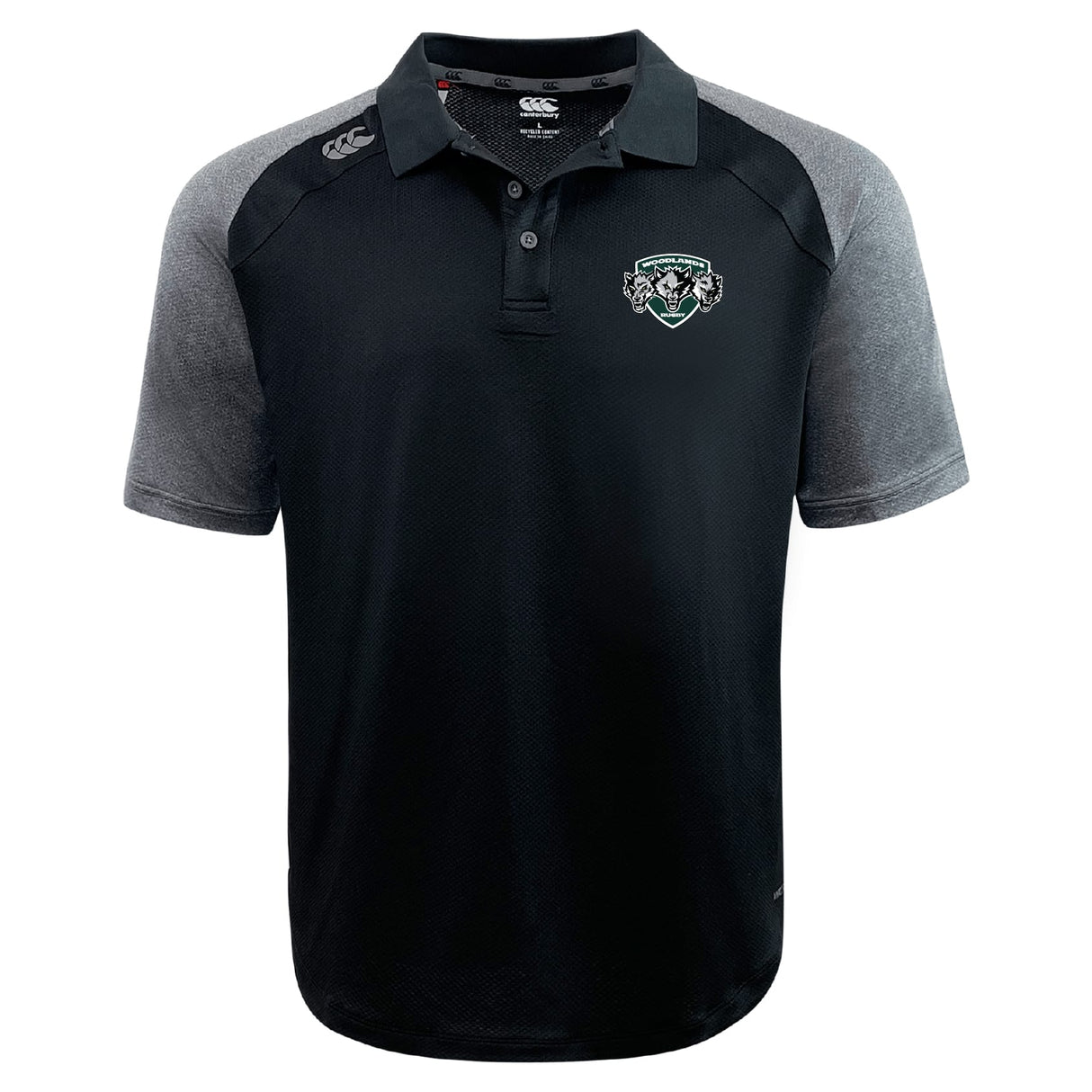 The Woodlands Youth Wolfpack Elite Polo by EMB Canterbury features black and gray Vapodri fabric for a lightweight feel, a button-up collar, embroidered left chest logo, and additional branding on the right shoulder and collar.