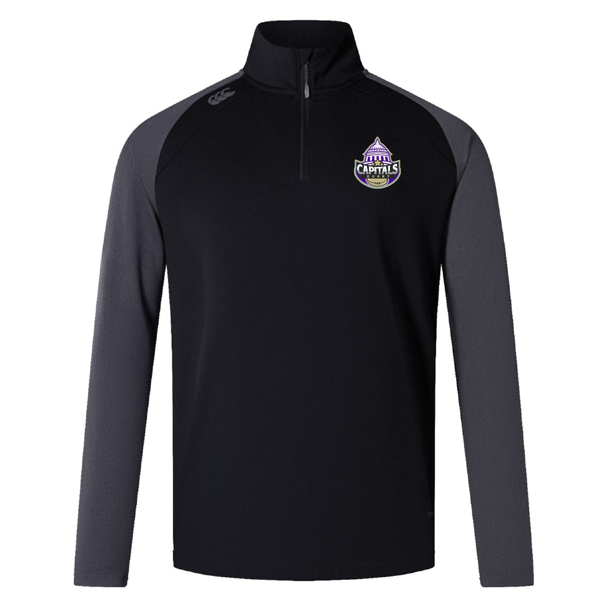 The EMB Canterbury Capitals Rugby NC Elite First Layer is a black training top with dark gray sleeves, a quarter-zip, VapoDri technology, and a Sacramento Capitals chest emblem.