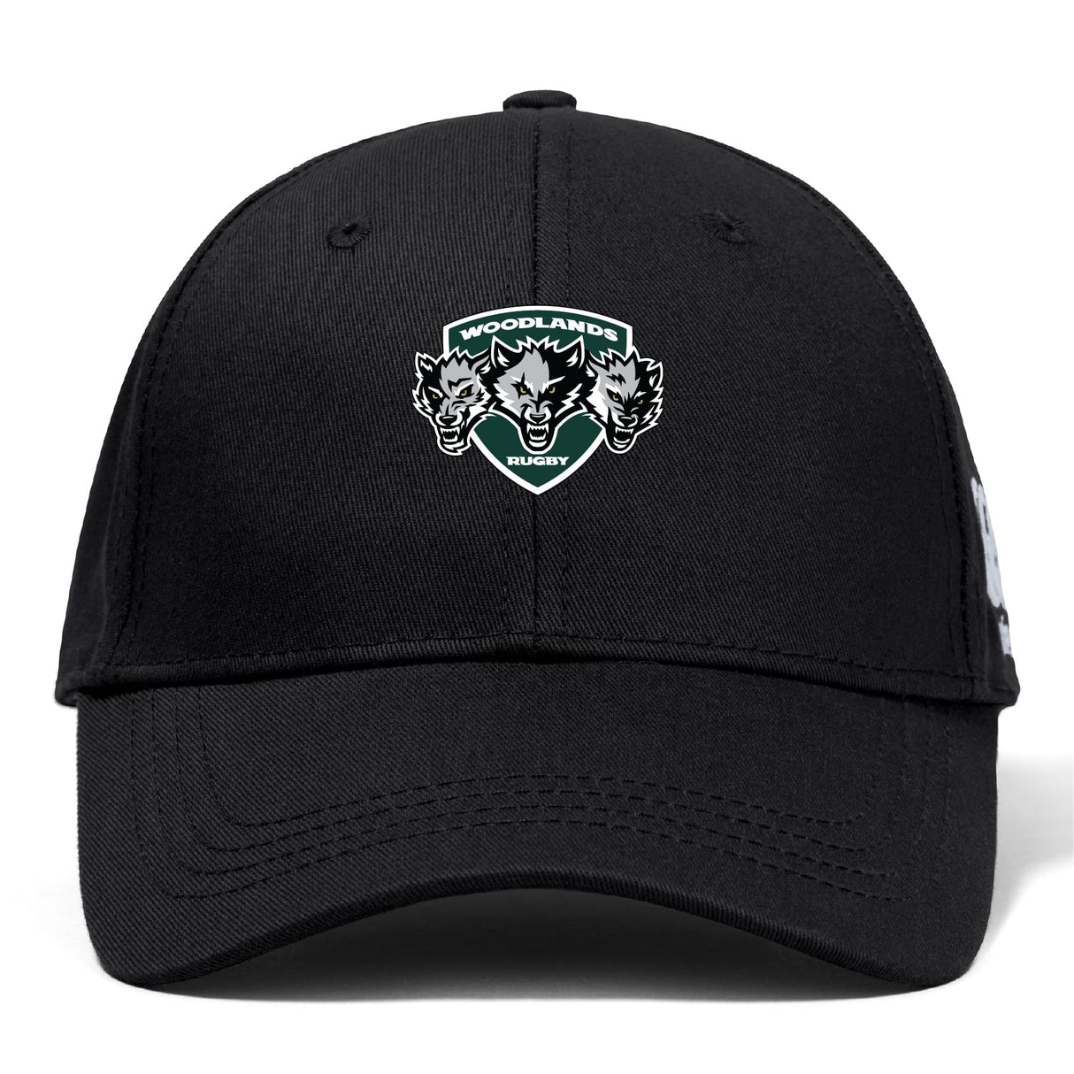 The Woodlands Youth Wolfpack Flexfit Drill Cap by Canterbury features an embroidered "Woodlands Rugby" logo with three wolf heads on the front. Brand: EMB Canterbury. Color: black.