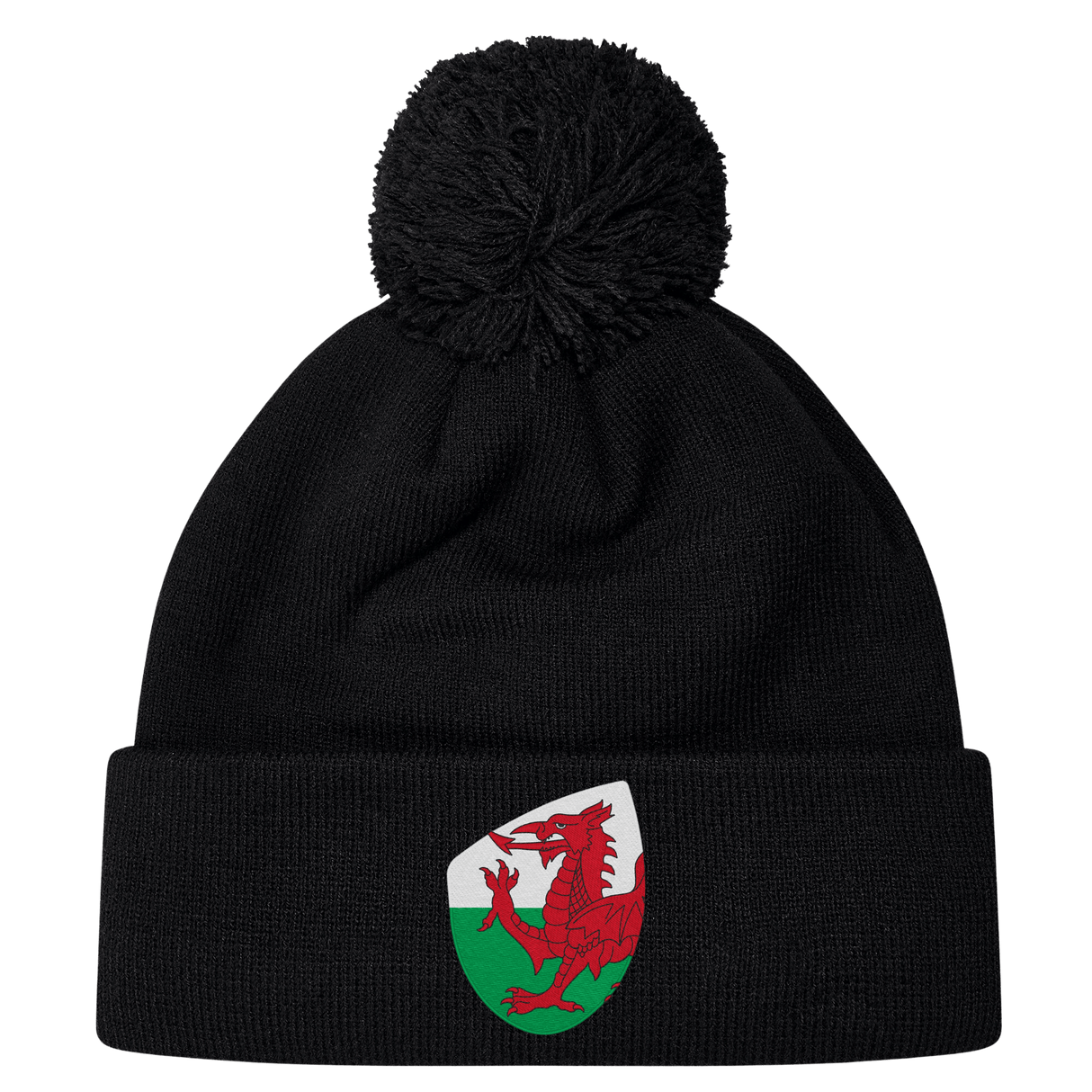 The EMB Canterbury Wales Shield Pom Pom Beanie is a stylish black beanie with a striking patch featuring a red dragon against a green and white backdrop, reminiscent of the Wales Shield.