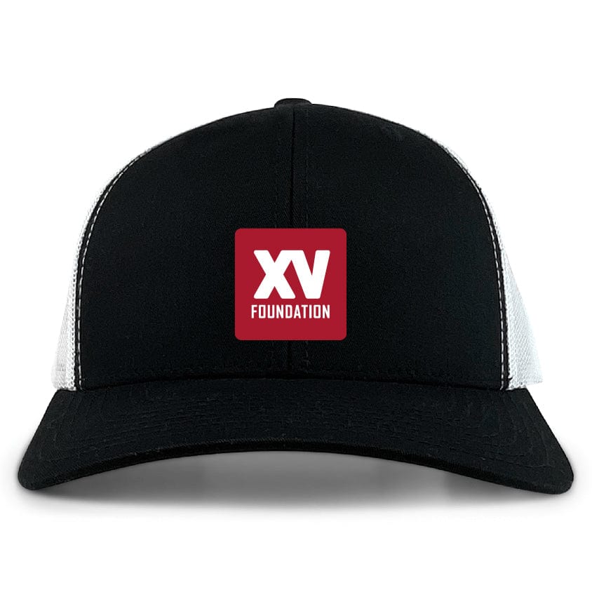 The EMB S&S Activewear XV Foundation Retro Trucker Cap features a black and white design, a red patch with "XV FOUNDATION" in white, crafted from polyester and cotton, and includes a snapback closure.