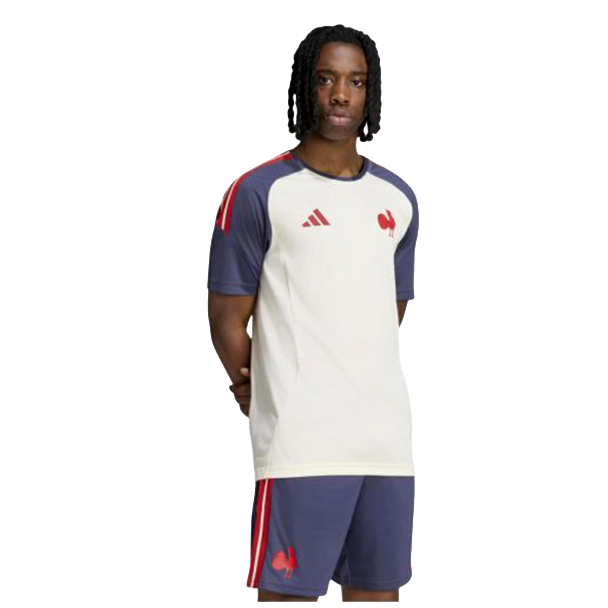 A person stands against a plain white background wearing the France FFR 26/27 Performance T-Shirt by adidas, a white and blue sports top with red accents that features the iconic rooster emblem and adidas logo, representing the French national rugby team.