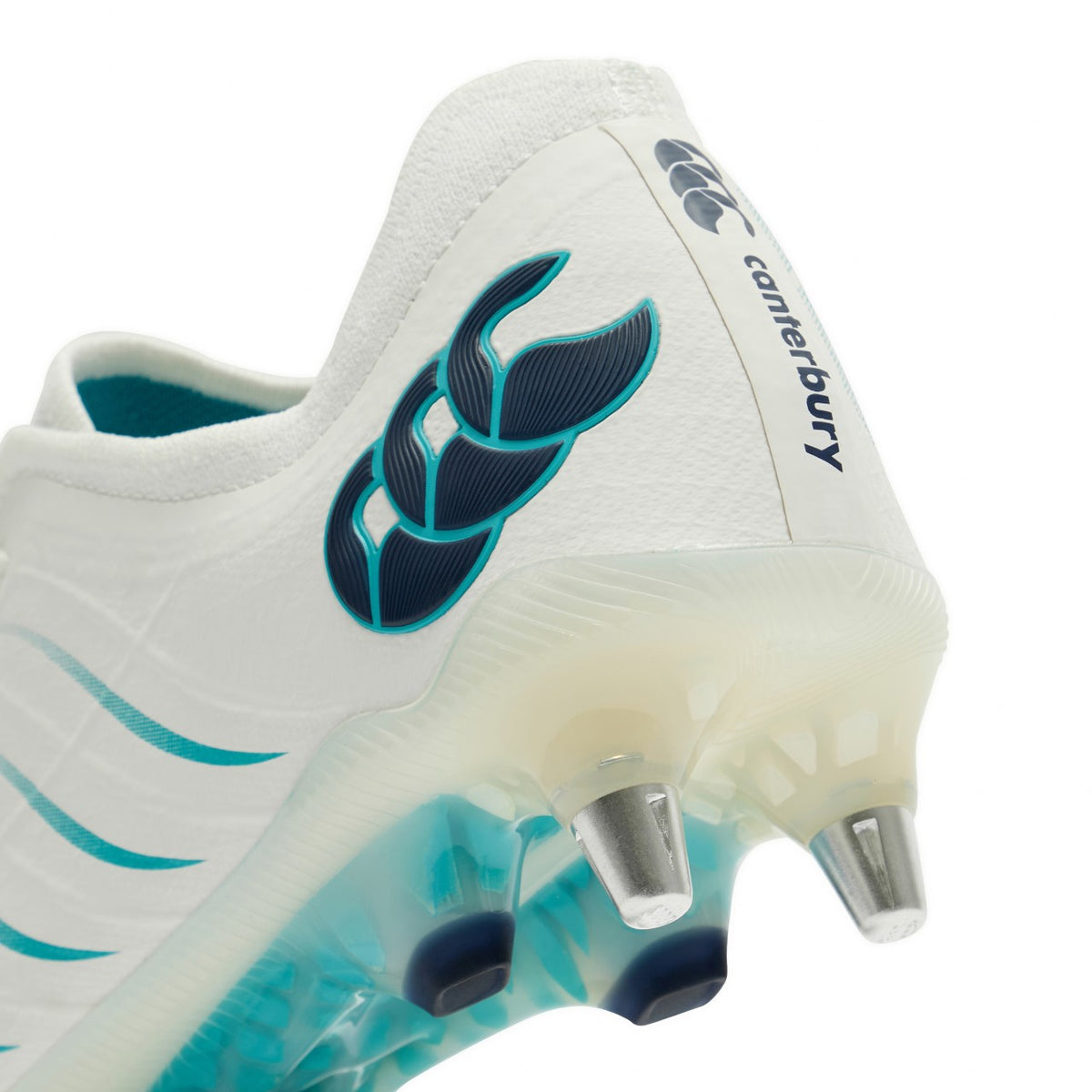 Close-up of the heel and sole of a Canterbury Phoenix 2.0 Elite SG - White/Baltic Green rugby boot with teal accents and metal studs.