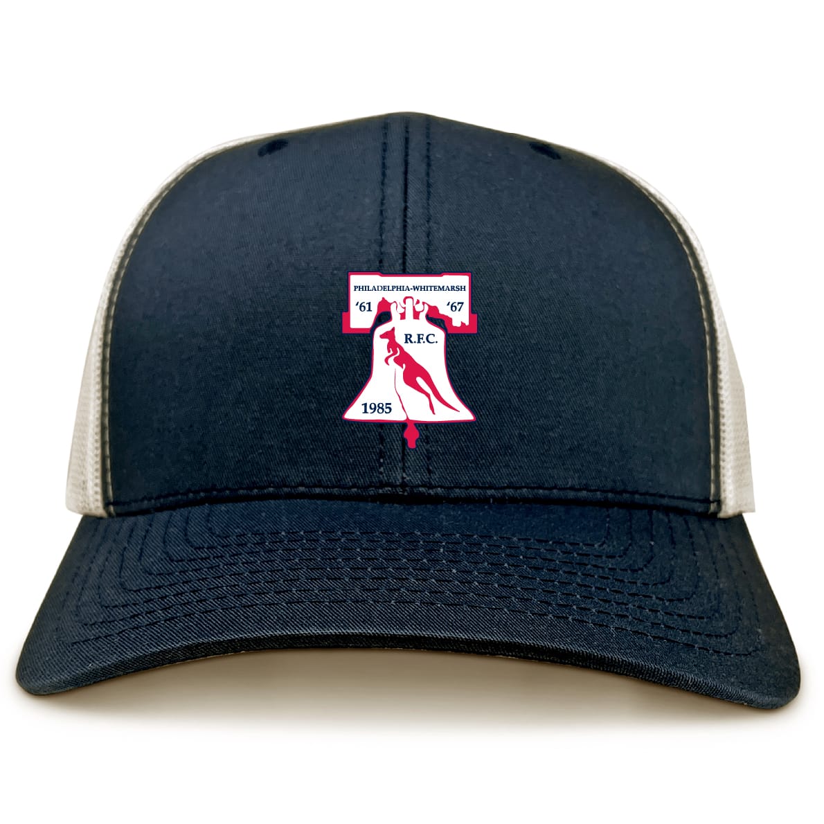 The Philly Whitemarsh RFC Retro Trucker Cap by EMB S&S Activewear features navy blue and beige panels, an embroidered club logo with a red rugby ball, "Philadelphia-Whitemarsh R.F.C. 1985" text, and an adjustable snapback closure.