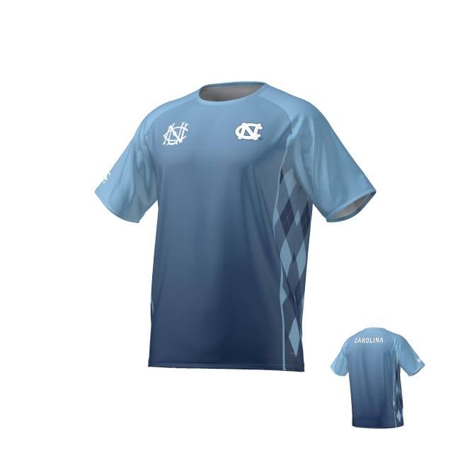 The Teamatical UNC Rugby Canterbury Performance Tee features a light blue and navy gradient, white UNC logos on the front, an argyle side pattern, and "Carolina" text on the upper back.