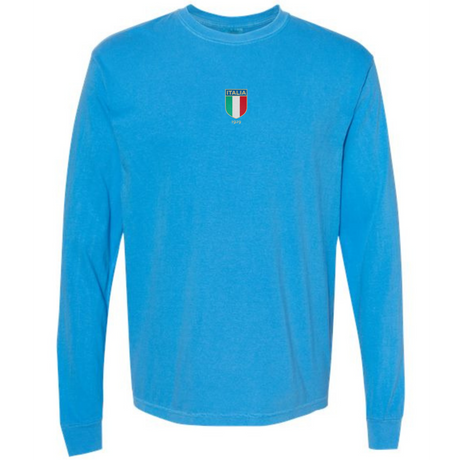 The Italy Vintage Long Sleeve Comfort Tee by EMB S&S Activewear features a light blue color, long sleeves, and a small Italia crest with Italian flag colors and text on the chest for a classic vintage vibe.