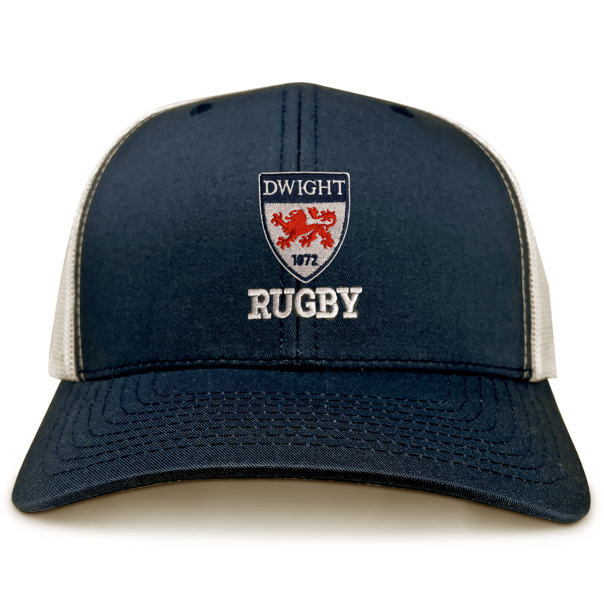 The Dwight Rugby Retro Trucker Cap by EMB S&S Activewear features a navy blue and white design, embroidered "Dwight Rugby," a crest with two red lions and "1872" on the front, plus an adjustable classic snapback closure.