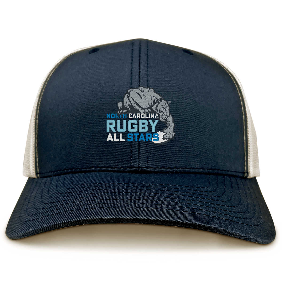 The EMB S&S Activewear NC All Stars Retro Trucker Cap features a navy and white design, embroidered "North Carolina Rugby All Stars" with a bulldog graphic on front, and a classic snapback closure for an adjustable fit.