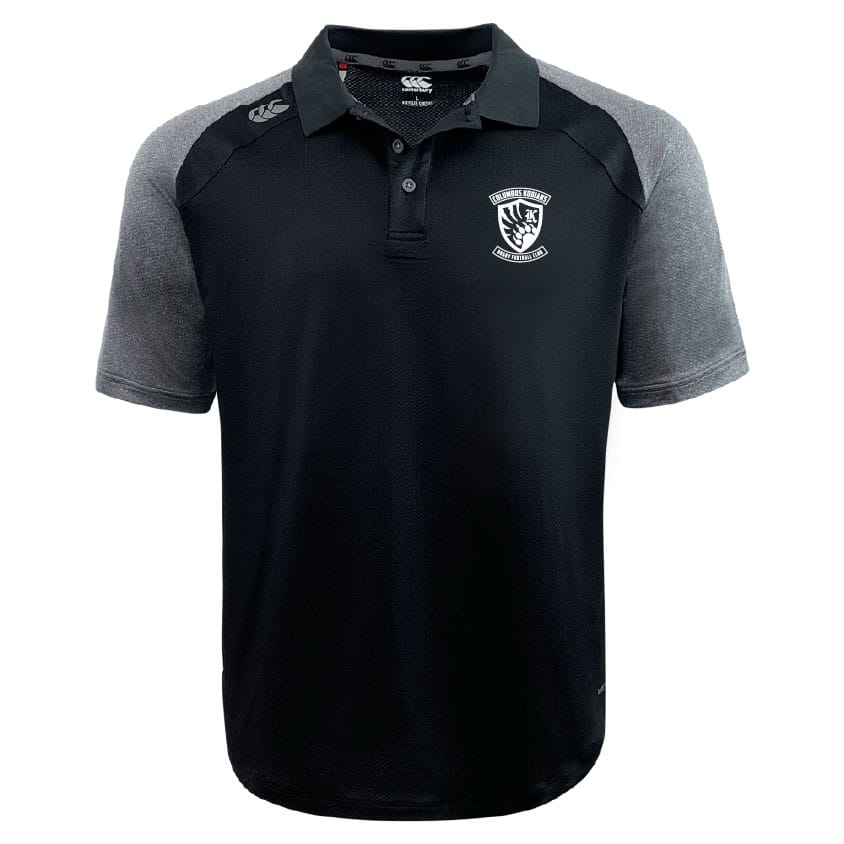 The Columbus Kodiaks Elite Polo by EMB Canterbury is a black short-sleeve shirt with gray sleeves and shoulders, featuring Vapodri fabric for comfort, a white embroidered crest, and the Canterbury logo on the right chest.