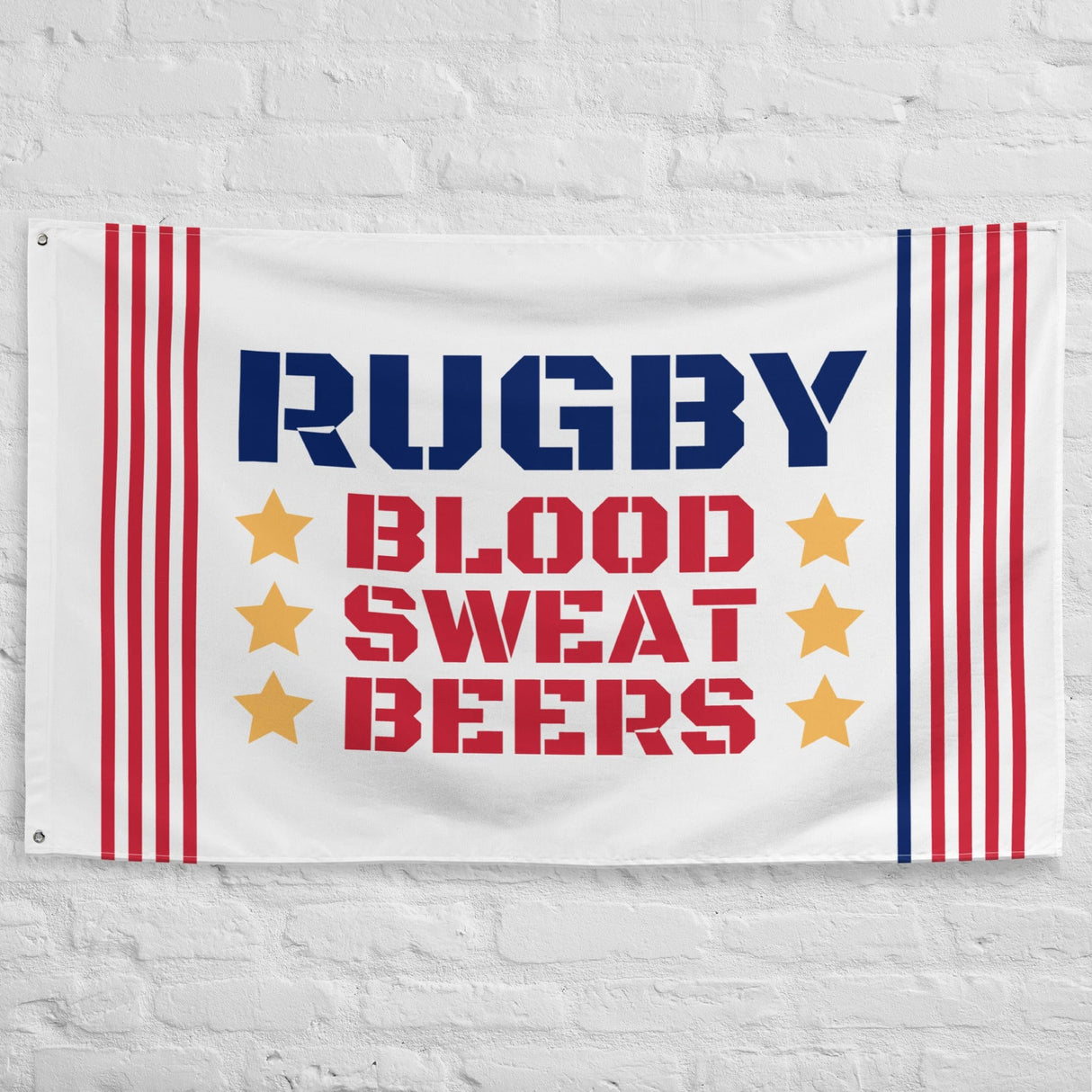 White brick wall with a white flag featuring red and blue stripes, yellow stars, and 'RUGBY, BLOOD, SWEAT, BEERS' inscription