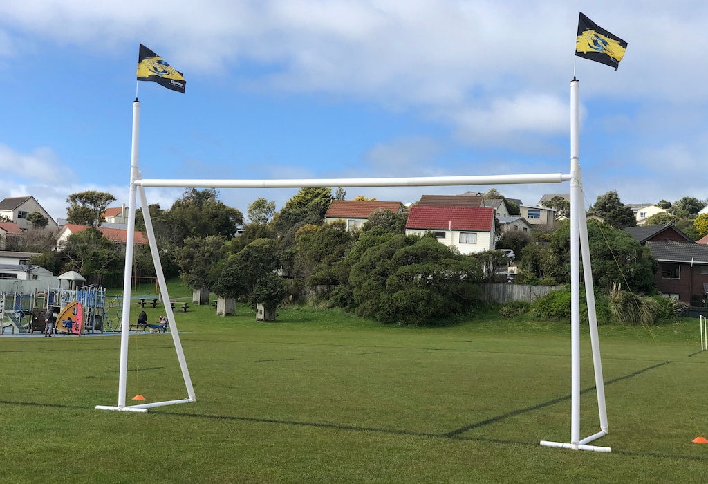 Portable and inflatable rugby posts on a field.