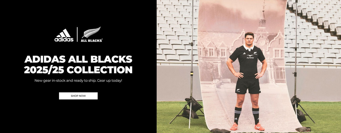 Rugby player in all blacks jersey catching a rugby ball.