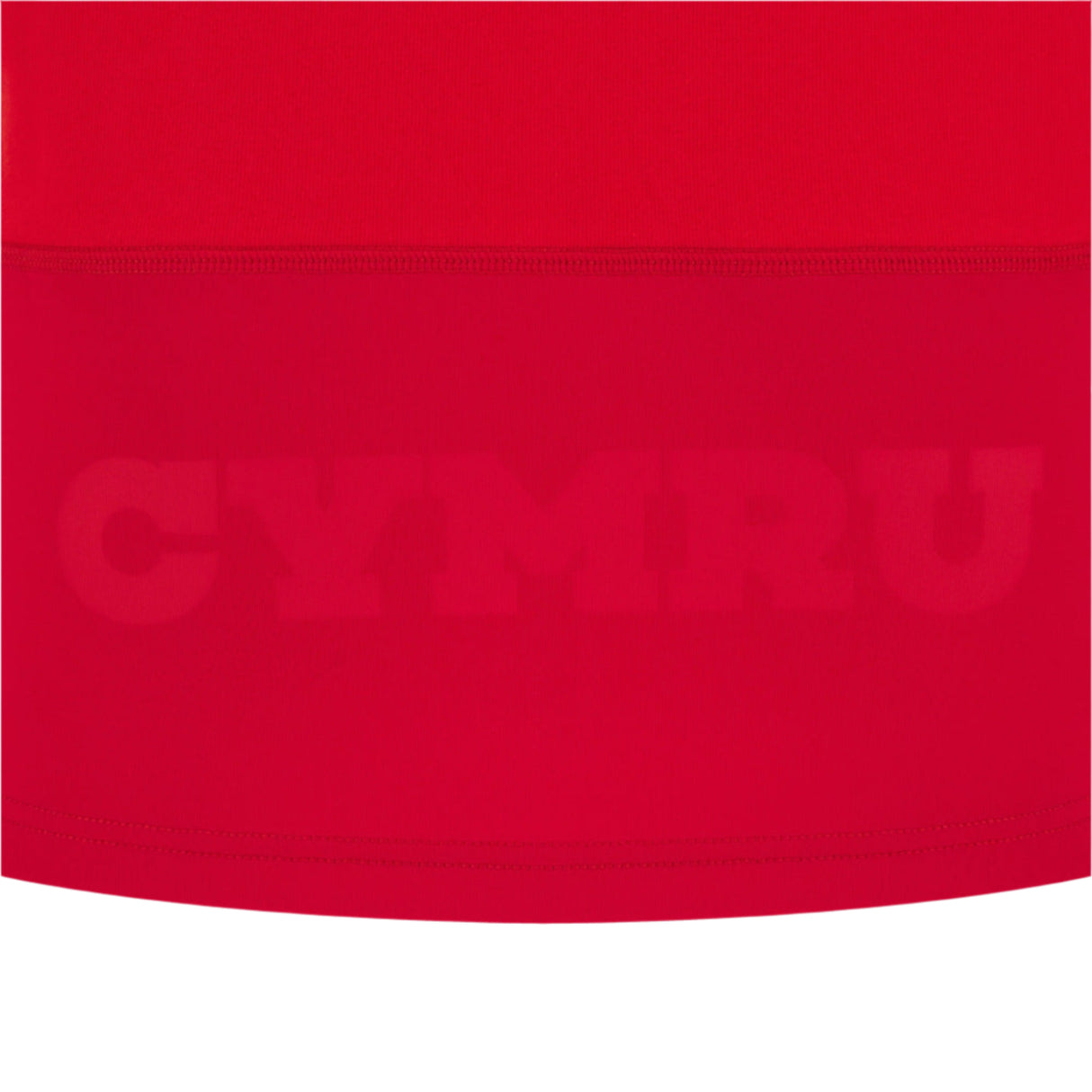 The Wales 25/26 Replica Home Cotton Jersey by Macron features red fabric with "CYMRU" subtly embossed in large capitals across the lower section, inspired by classic Wales rugby jerseys.