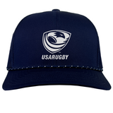 The EMB Augusta USA Rugby Navy/White Crest Braid Cap features the USA Rugby logo and "USARUGBY" text on the front, with stylish white trim on the brim.