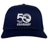 Celebrate USA Rugby's 50th with the EMB Augusta navy blue trucker snapback braid cap, featuring a white "50" logo with stars and a stylized eagle.