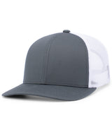 Augusta Sportswear's Trucker Snapback Cap features a gray and white mesh design with a curved brim, highlighting its mid-profile appearance from a slight angle. The pro-stitched finish enhances both durability and style.