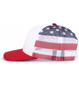 The Augusta Sportswear Printed Flag Trucker Cap features a red bill, white front panel, mesh back, and a bold American flag design with stars and stripes.