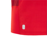 Close-up of the lower section of the Wales 25/26 Replica Home Jersey by Macron, featuring a small white eco label near the hem, set against a light gray background.