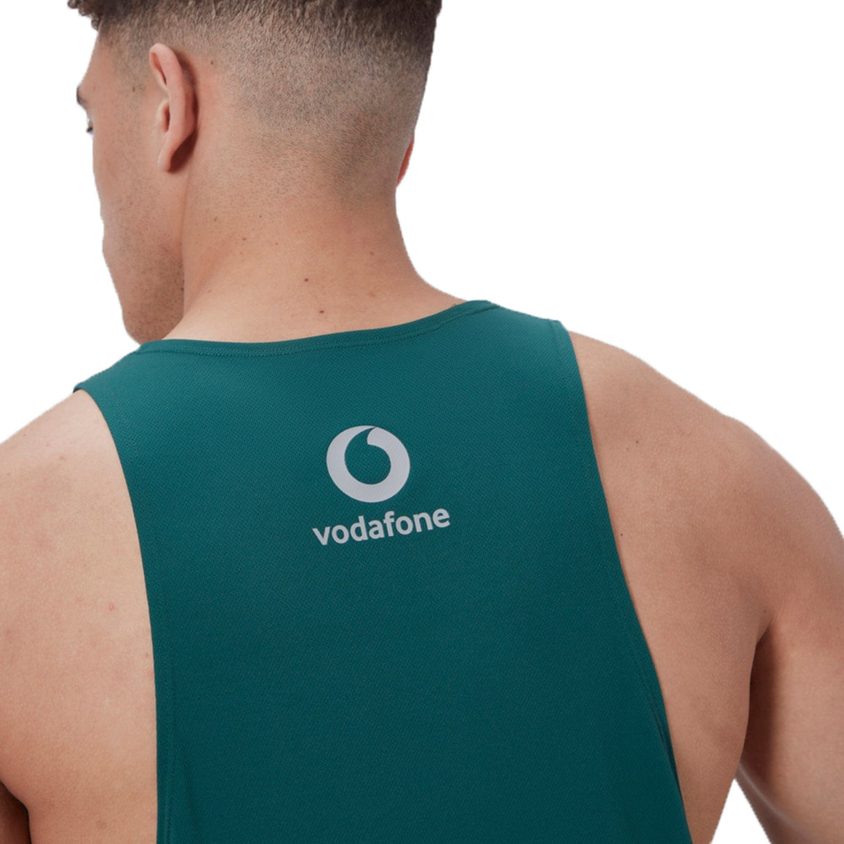 Someone wears a teal, quick-drying fabric Ireland 24 Poly Training Singlet by Canterbury, featuring a Vodafone logo on the back.