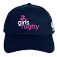 The Girls Rugby Flexfit Drill Cap by EMB Canterbury is a navy blue curved brim cap featuring "girls rugby" in pink and white on the front and a white CCC logo on the side.