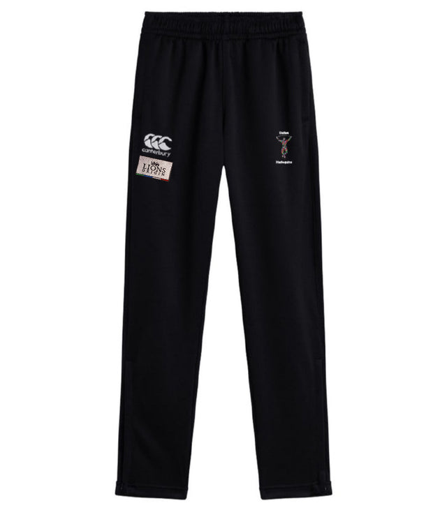 The EMB Canterbury Dallas Harlequins Lions Origin Stretch Tapered Pant features an elastic waistband and multiple embroidered logos on the upper legs for comfort and style, perfect for active days.