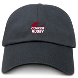 The EMB S&S Activewear Guilford College Adult Low-Profile Cotton Twill Dad Cap features "QUAKER RUGBY" and a rugby ball logo embroidered in red and white—a classic team hat for rugby fans.