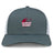 The Guilford College Retro Trucker Cap by EMB S&S Activewear is a gray and white mesh-back hat with an embroidered maroon rugby ball and "Quaker Rugby" on the front, plus a classic snapback closure for adjustable fit.