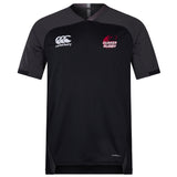 The Guilford College Vapodri Evader Jersey by EMB Canterbury is a black short-sleeve rugby jersey featuring "Canterbury" and "Quaker Rugby" chest logos, a V-neck, subtle paneling, and VapoDri finish for added comfort.