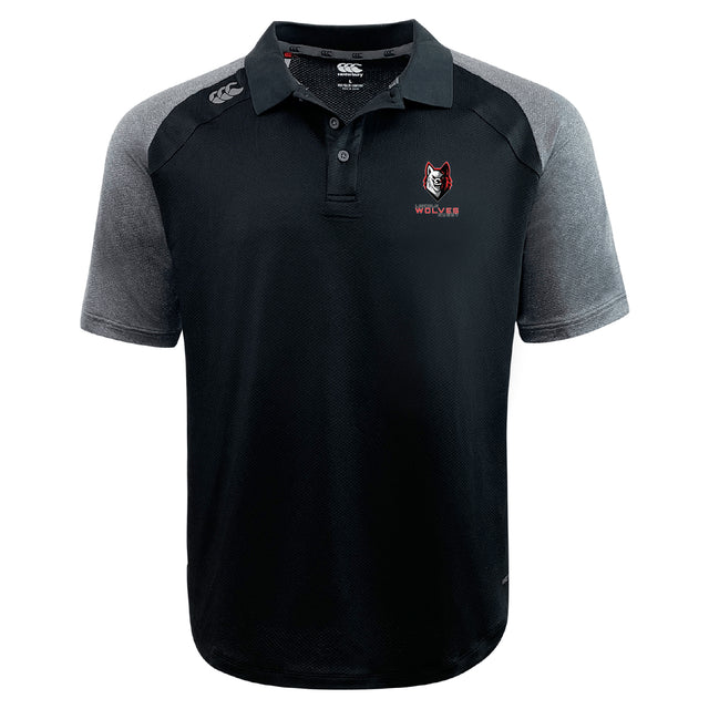 The Lincoln Wolves Elite Polo by EMB Canterbury features black and gray colors, a wolf logo with "WOLVES" on the left chest, a white Canterbury logo on the right shoulder, and lightweight Vapodri fabric for comfort and performance.