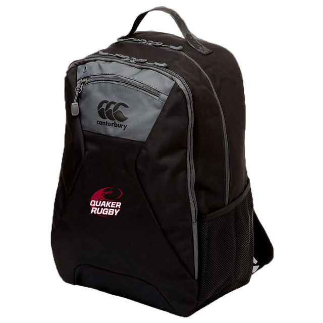 The Guilford College Medium Backpack by EMB Canterbury features water-repellent material, front and side zippered pockets, mesh side pocket, padded laptop pocket, and "QUAKER RUGBY" logo on the front.