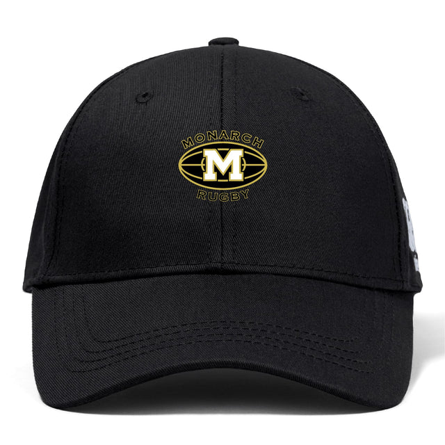 The Monarch Rugby Club Flexfit Drill Cap by EMB Canterbury features a gold and white "Monarch Rugby" embroidered logo with a large "M" inside a rugby ball shape on the front.