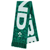 The Ireland 25/26 Scarf by Canterbury is a green official IRFU scarf featuring bold white lettering, the iconic shamrock logo, and stylish fringe at one end. Displayed against a white background, this Canterbury scarf is perfect for any Ireland rugby supporter.