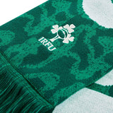 The Ireland 25/26 Scarf by Canterbury features green and white colors with the IRFU shamrock logo and a fringed edge, making it an official Ireland scarf—perfect for any passionate rugby supporter.