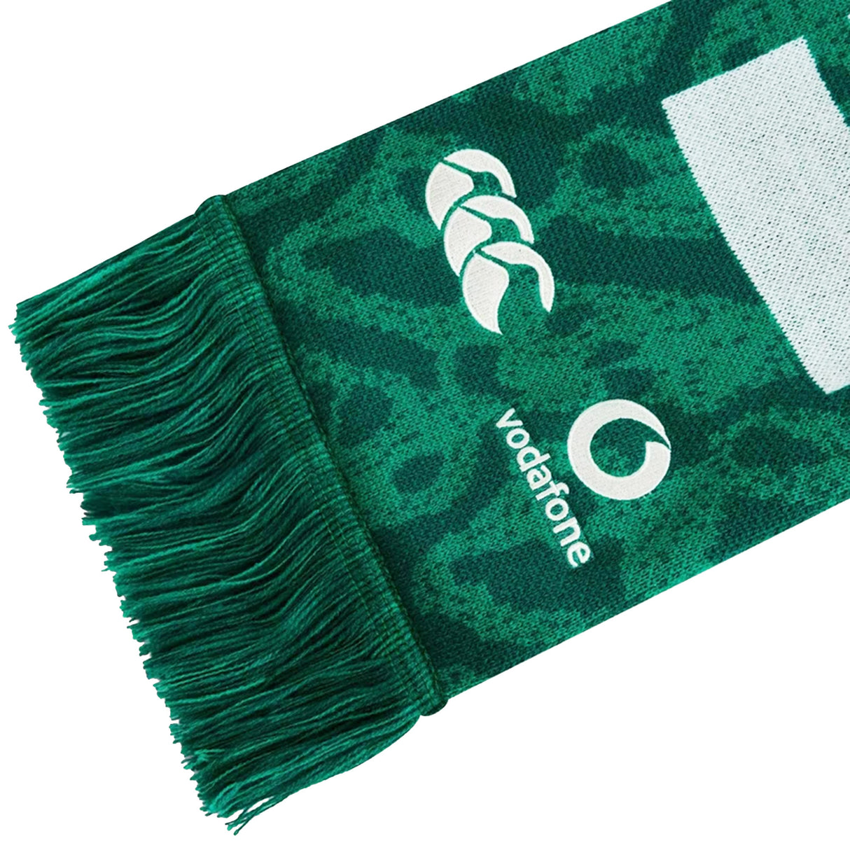 Show your support with the Ireland 25/26 Scarf by Canterbury—a green scarf featuring dark patterns, fringed edges, and white Canterbury and Vodafone logos on the fabric. This official Ireland rugby scarf is perfect for fans.