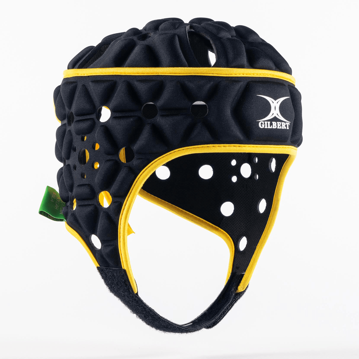 A lightweight black headguard with yellow trim, honeycomb padding for shock absorption, and circular ventilation holes branded with the "Gilbert" logo on the front. Endorsed as the Gilbert Limited Edition Cheslin Kolbe Air Headguard.