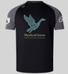 The Mystical Geese Elite Training Tee by Canterbury from WRS Canterbury features a black and gray rugby jersey design with a stylized goose graphic, “Mystical Geese,” and “Vancouver Golden Oldies 2027” on the front, plus sleeve patches. Made from Vapodri fabrics for superior comfort, this lightweight and durable tee is ideal for both fans and players of the Mystical Geese Elite Training Tee collection.